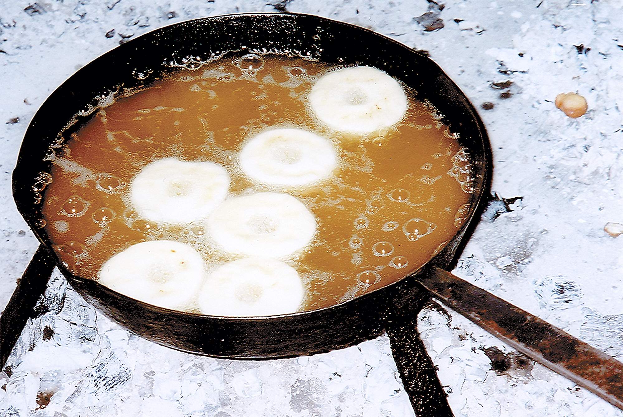 Hot cooking grease bubbles as fasnachts float to the top of the skillet during “Fasnacht Making Day” in 2006 at the Landis Valley Village & Farm Museum in Lancaster, Pennsylvania.